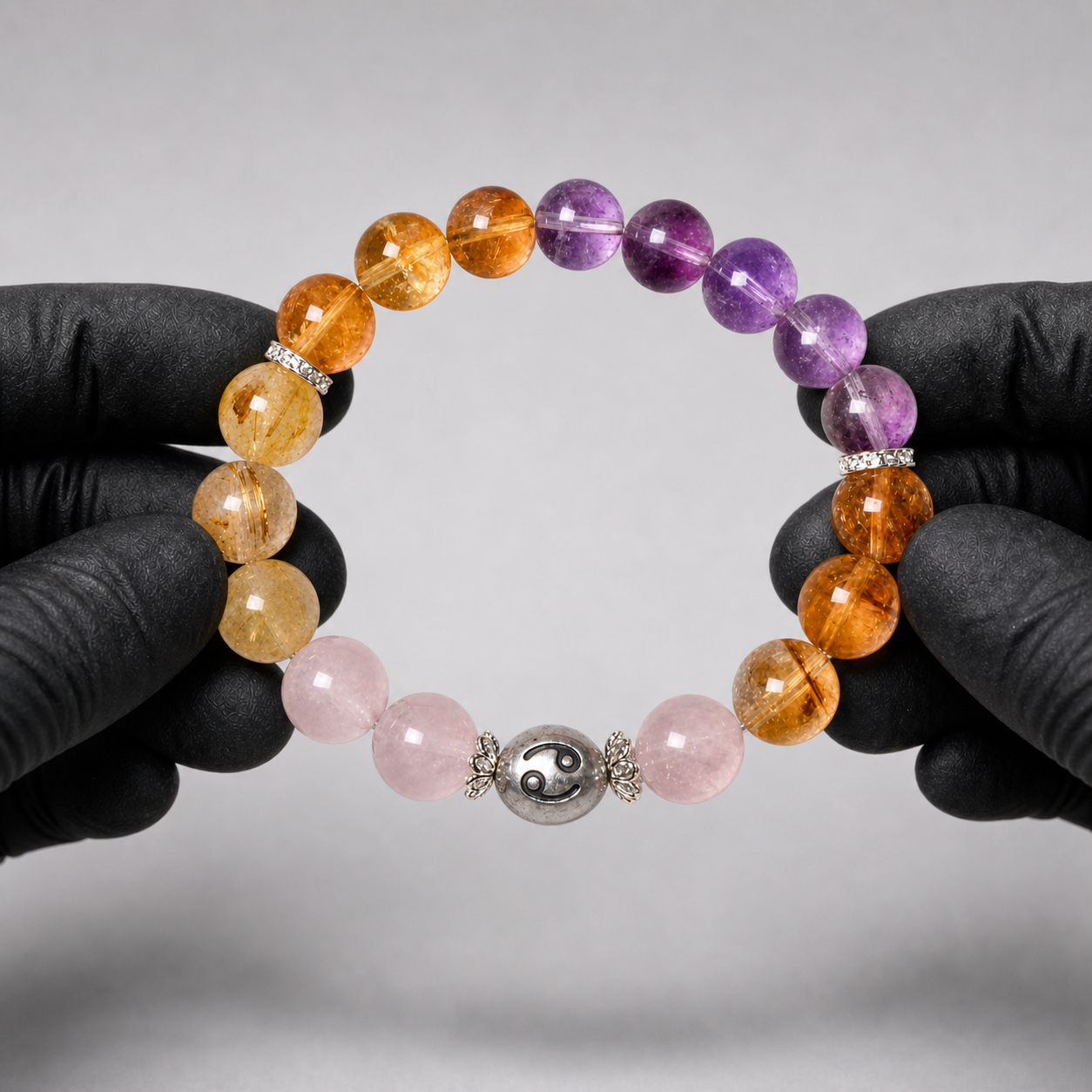 Cancer crystal bracelet being inspected for crystal arrangement and finish details