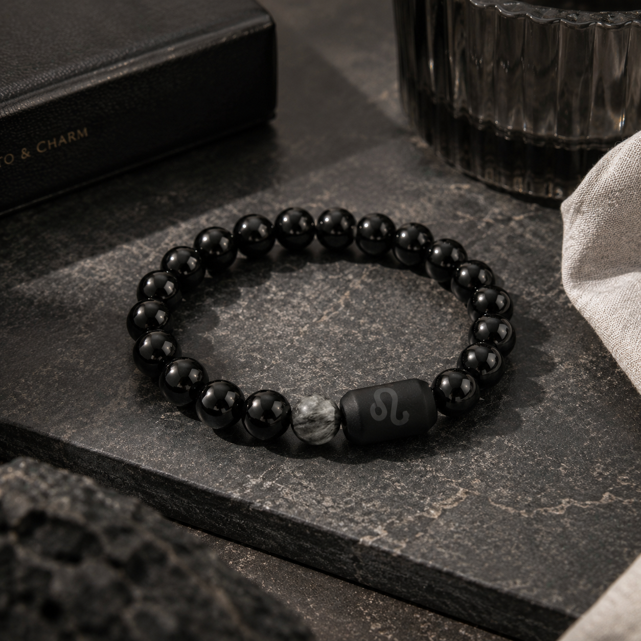 Leo zodiac bracelet with black obsidian and Tiger’s Eye beads in a dark styled setting stone