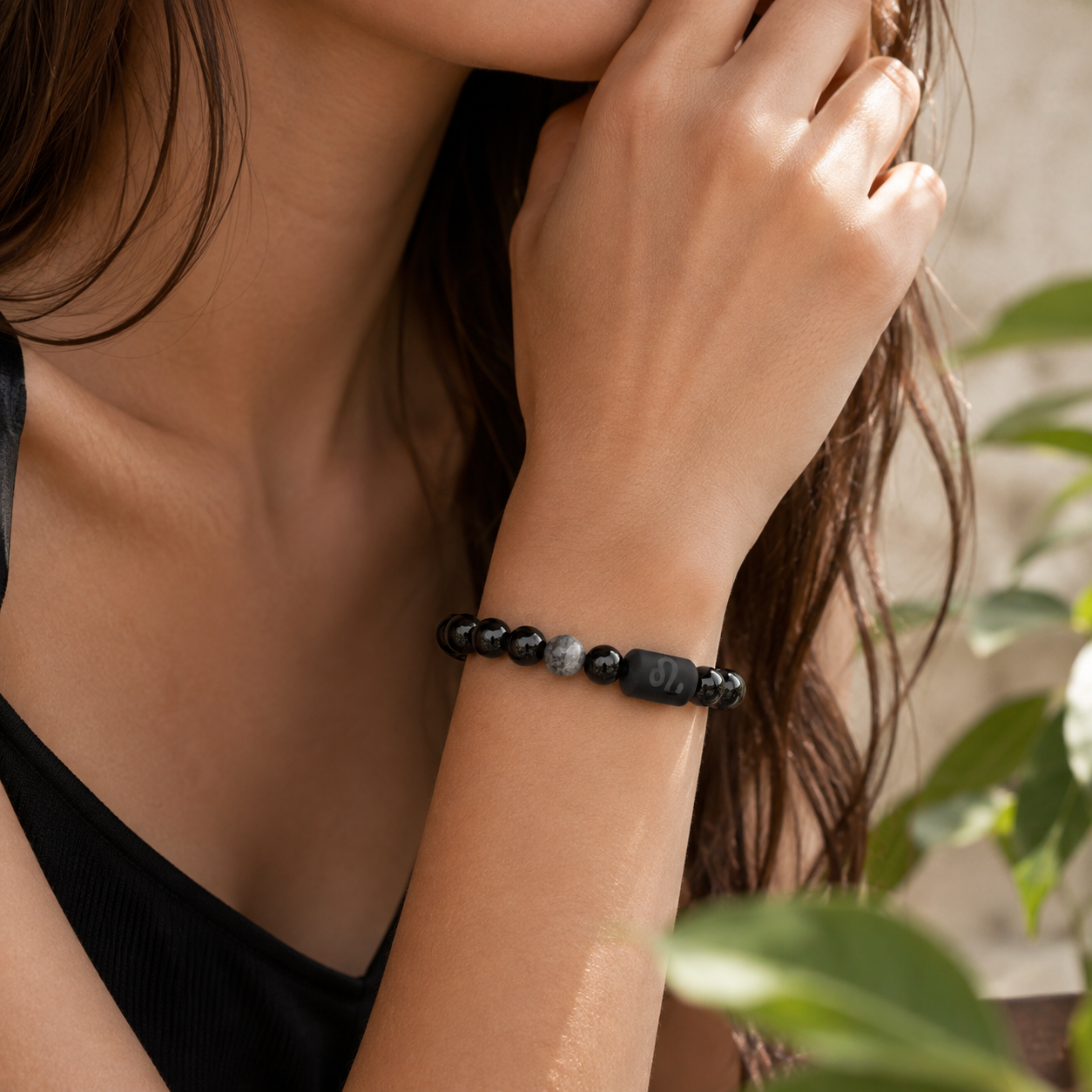 Woman wearing a Leo Zodiac Bracelet with obsidian and Tiger’s Eye beads