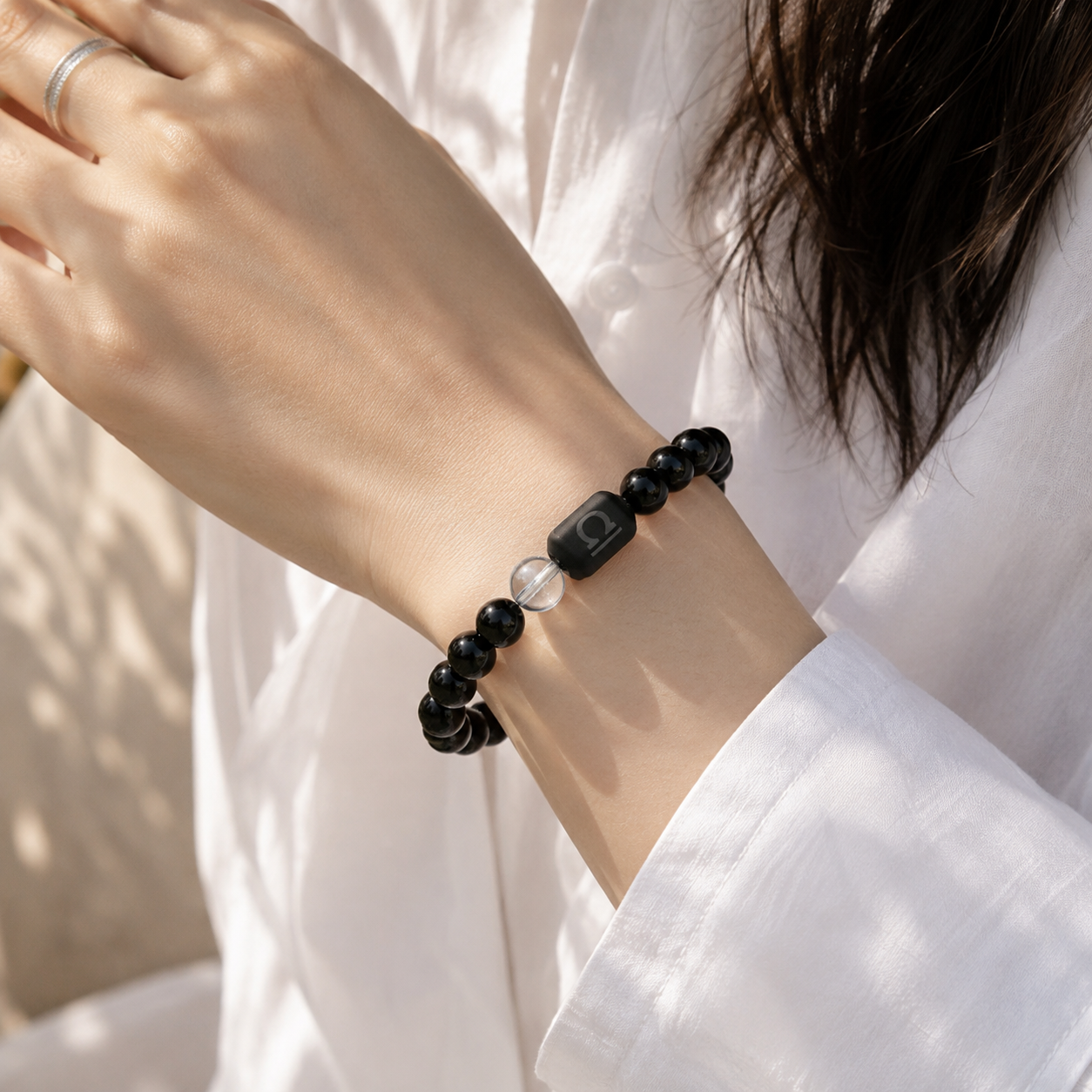 Woman wearing a Libra Zodiac Bracelet with obsidian and Tiger’s Eye beads