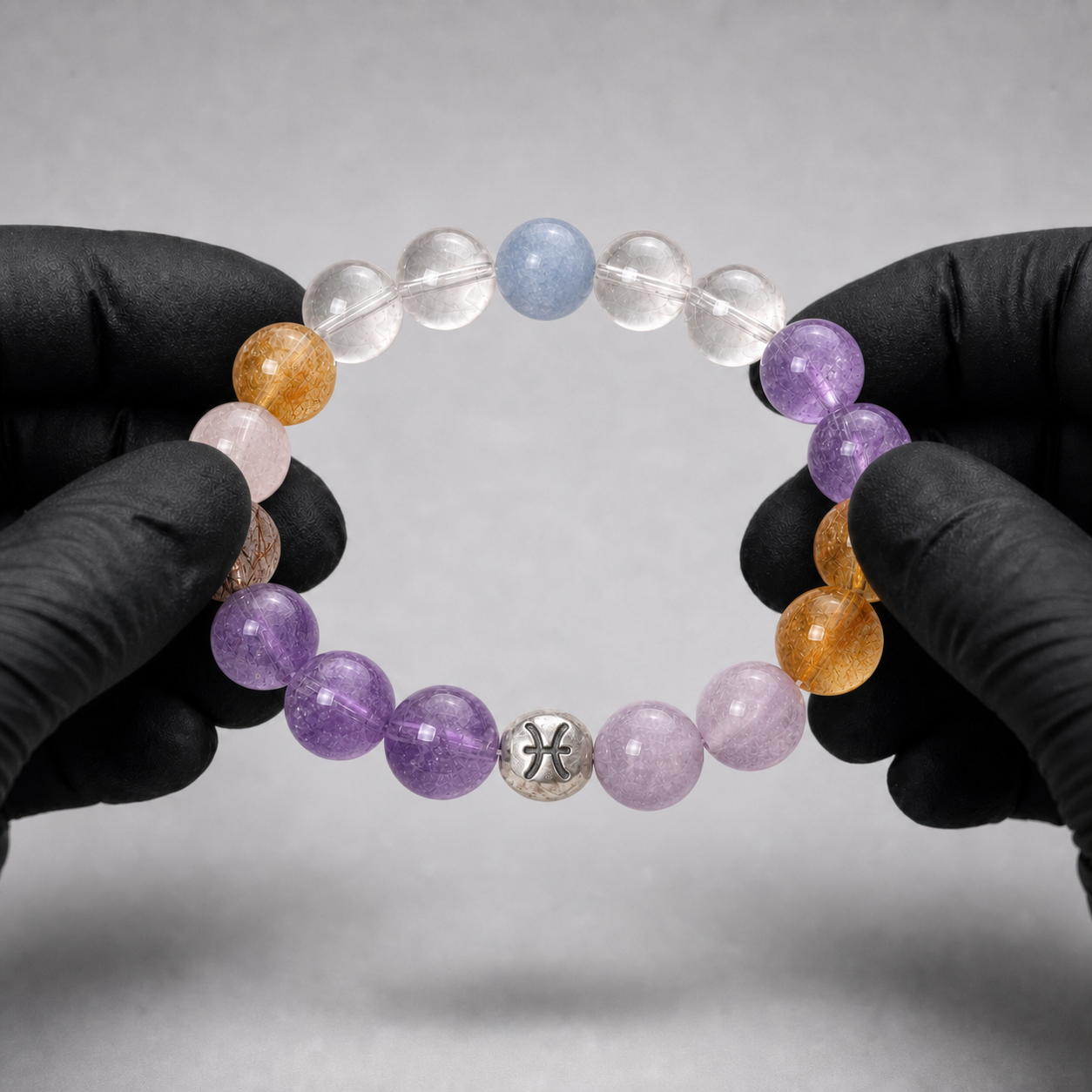 Pisces crystal bracelet being inspected for crystal arrangement and finish details