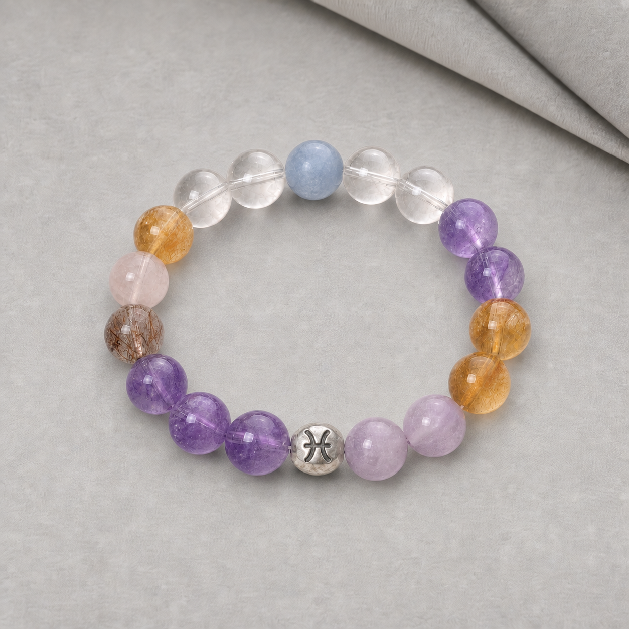Pisces bracelet with purple, blue, pink and clear crystal beads displayed in warm sunlight