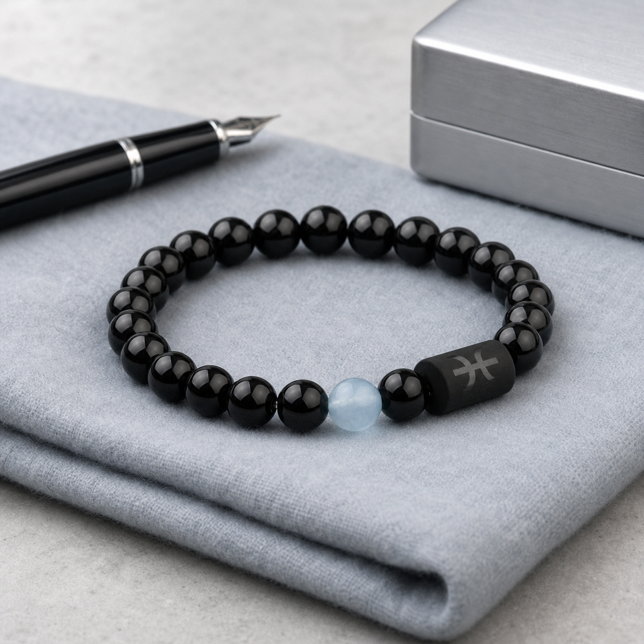 Pisces zodiac bracelet with black obsidian and Tiger’s Eye beads in a soft styled setting
