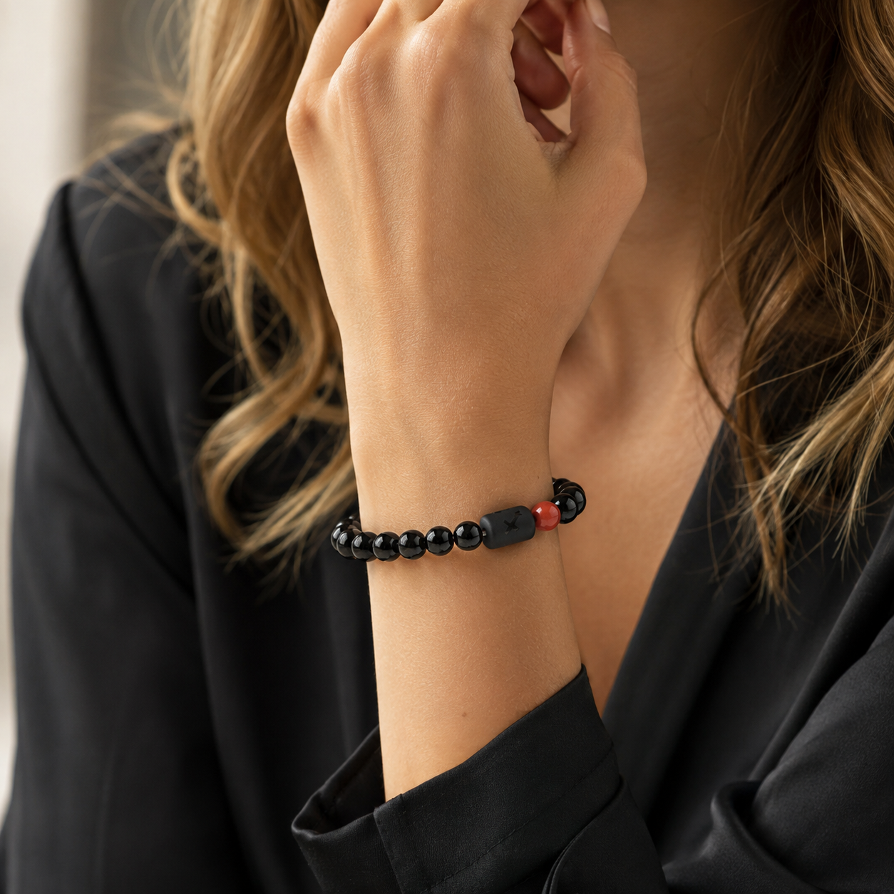 Woman wearing a Sagittarius Zodiac Bracelet with obsidian and Tiger’s Eye beads