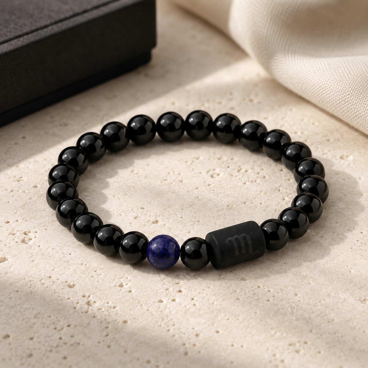 Obsidian and Tiger’s Eye Scorpio bracelet displayed in warm sunlight natraul