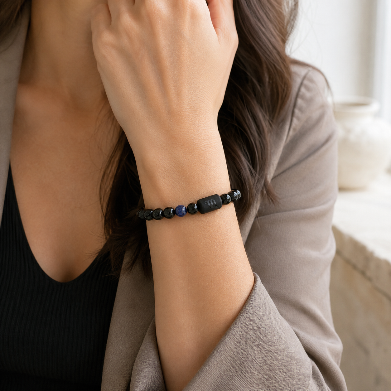 Woman wearing a Scorpio Zodiac Bracelet with obsidian and Tiger’s Eye beads women