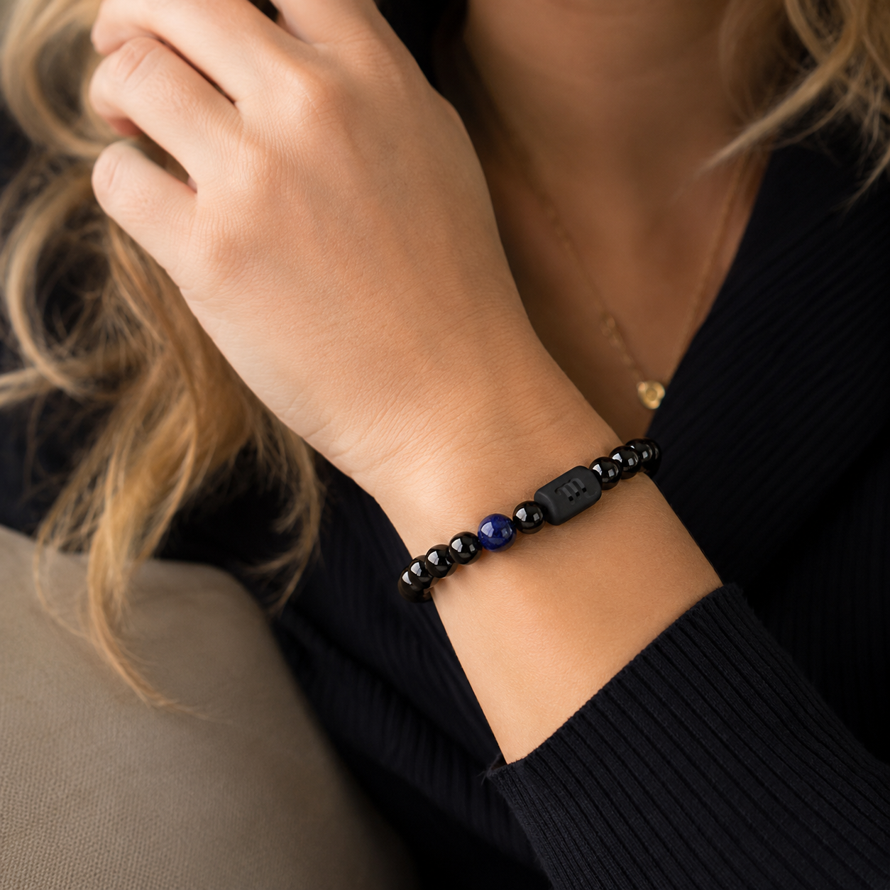Woman wearing a Scorpio Zodiac Bracelet with obsidian and Tiger’s Eye beads