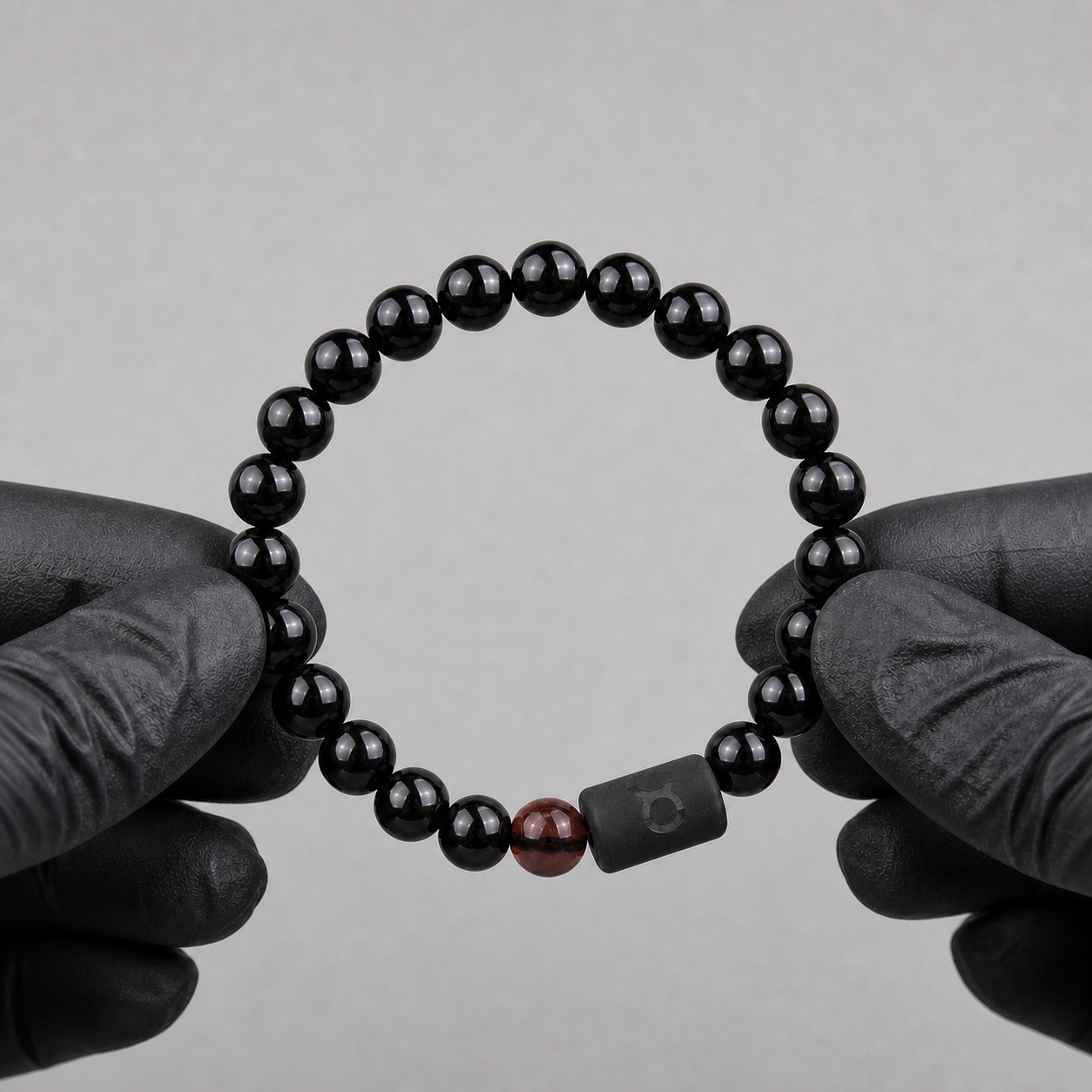 Obsidian and Tiger’s Eye Taurus bracelet displayed in warm sunlight