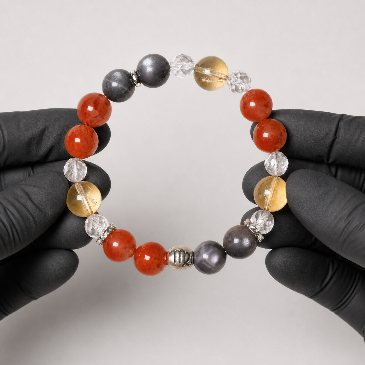 Virgo crystal bracelet being inspected for crystal arrangement and finish details