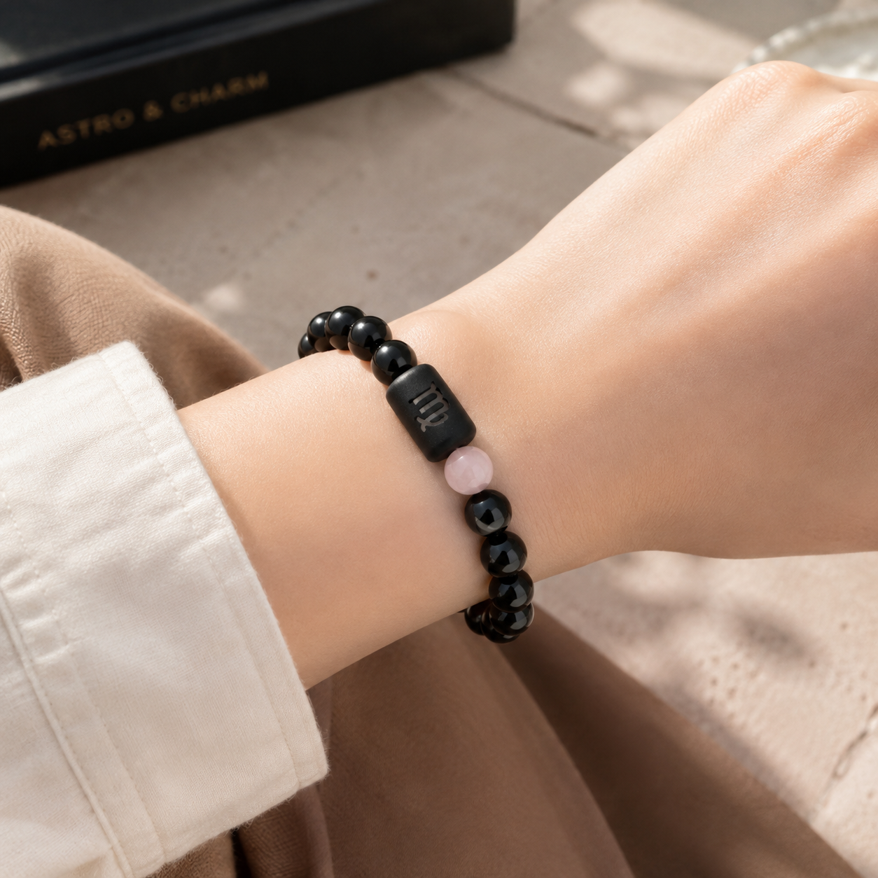 Woman wearing a Virgo Zodiac Bracelet with obsidian and Tiger’s Eye beads